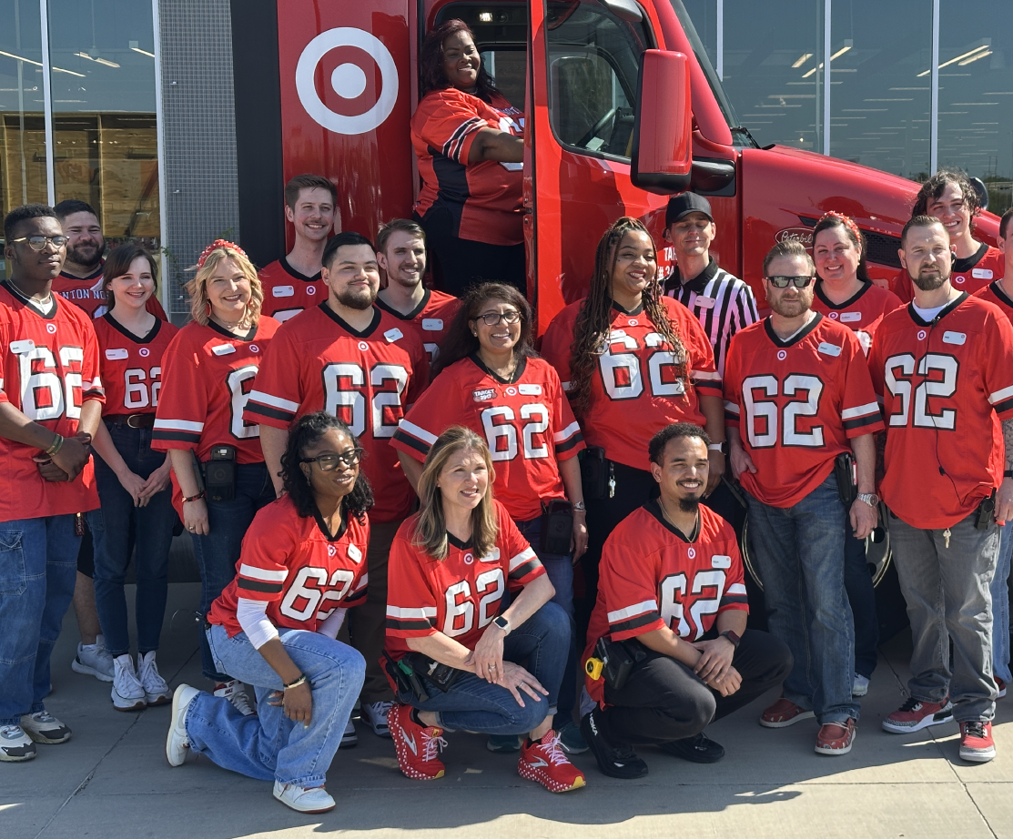 The Target Denton team poses for a photo near a large truck.
